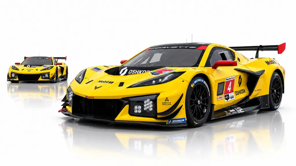Two bright yellow Corvette Z06 GT3.R race cars are shown on a clean white background with soft mirrored reflections beneath them. The No. 4 Oshkosh-sponsored Corvette dominates the foreground in a three-quarter front view, while a second matching car appears smaller in the left background.
