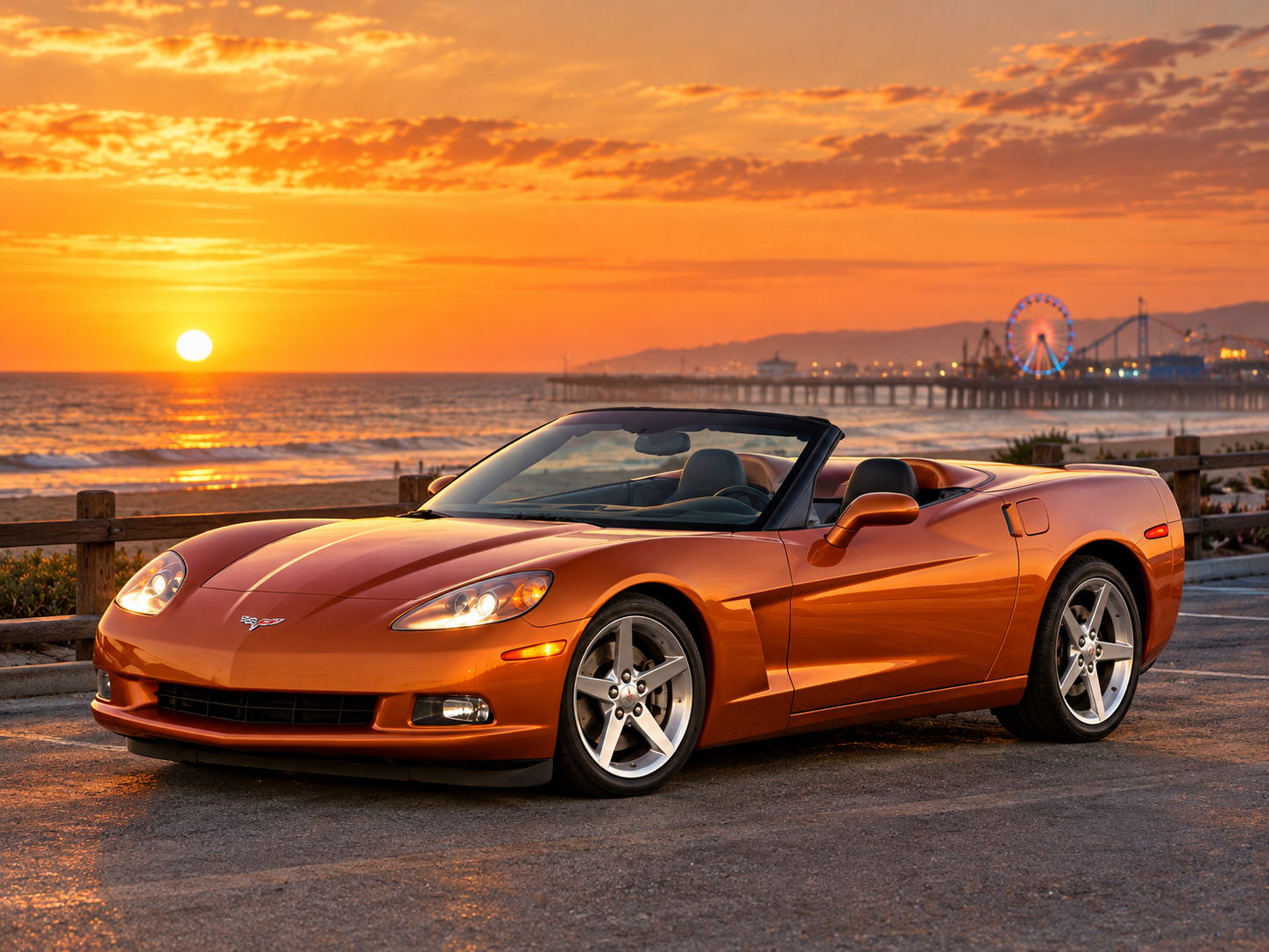 Sunset Orange Chevrolet Corvette C6 convertible with its top lowered, parked along a coastal boardwalk overlooking the Pacific Ocean at sunset. Warm golden sunlight reflects across the Corvette's sculpted bodywork and polished five-spoke wheels, while a distant amusement pier and illuminated Ferris wheel rise above the shoreline. The scene illustrates the standard 2006 Corvette's combination of performance, open-air touring capability, and everyday versatility.