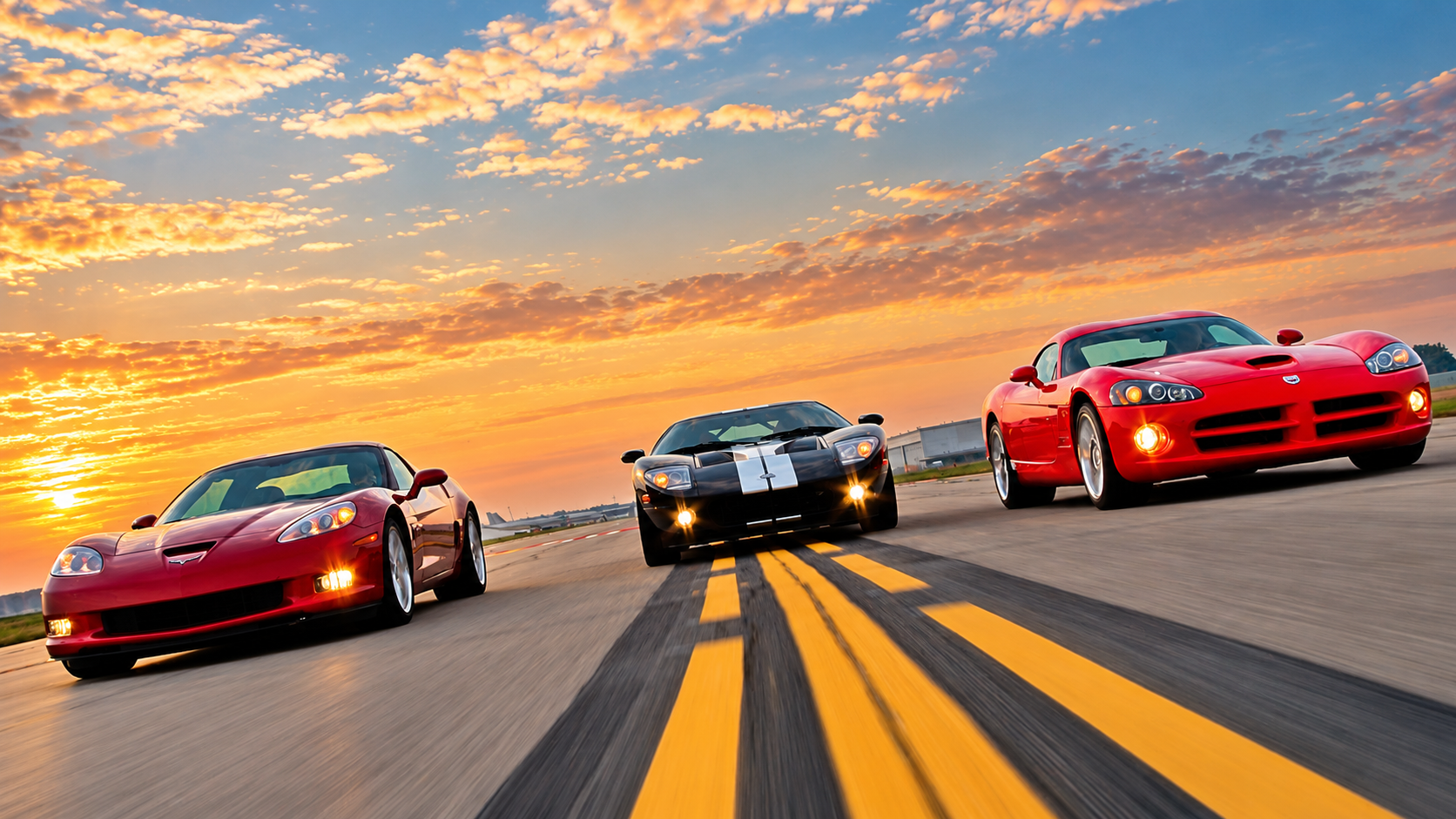 Red 2006 Chevrolet Corvette Z06, black Ford GT with white racing stripes, and red Dodge Viper SRT10 photographed accelerating side by side on a runway. The Corvette occupies the left side of the image, with the Ford GT in the center and Dodge Viper on the right, illustrating the intense competition among America's premier high-performance sports cars during the 2006 model year.